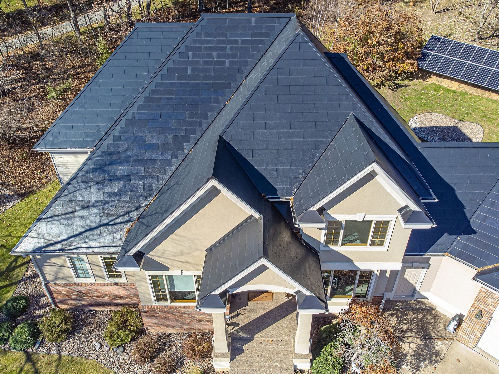Front facade of home with Tesla Solar Roof — seamless glass shingle integration