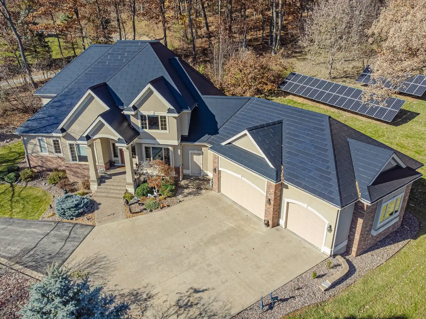 Home with Tesla Solar Roof glass tiles, aerial view